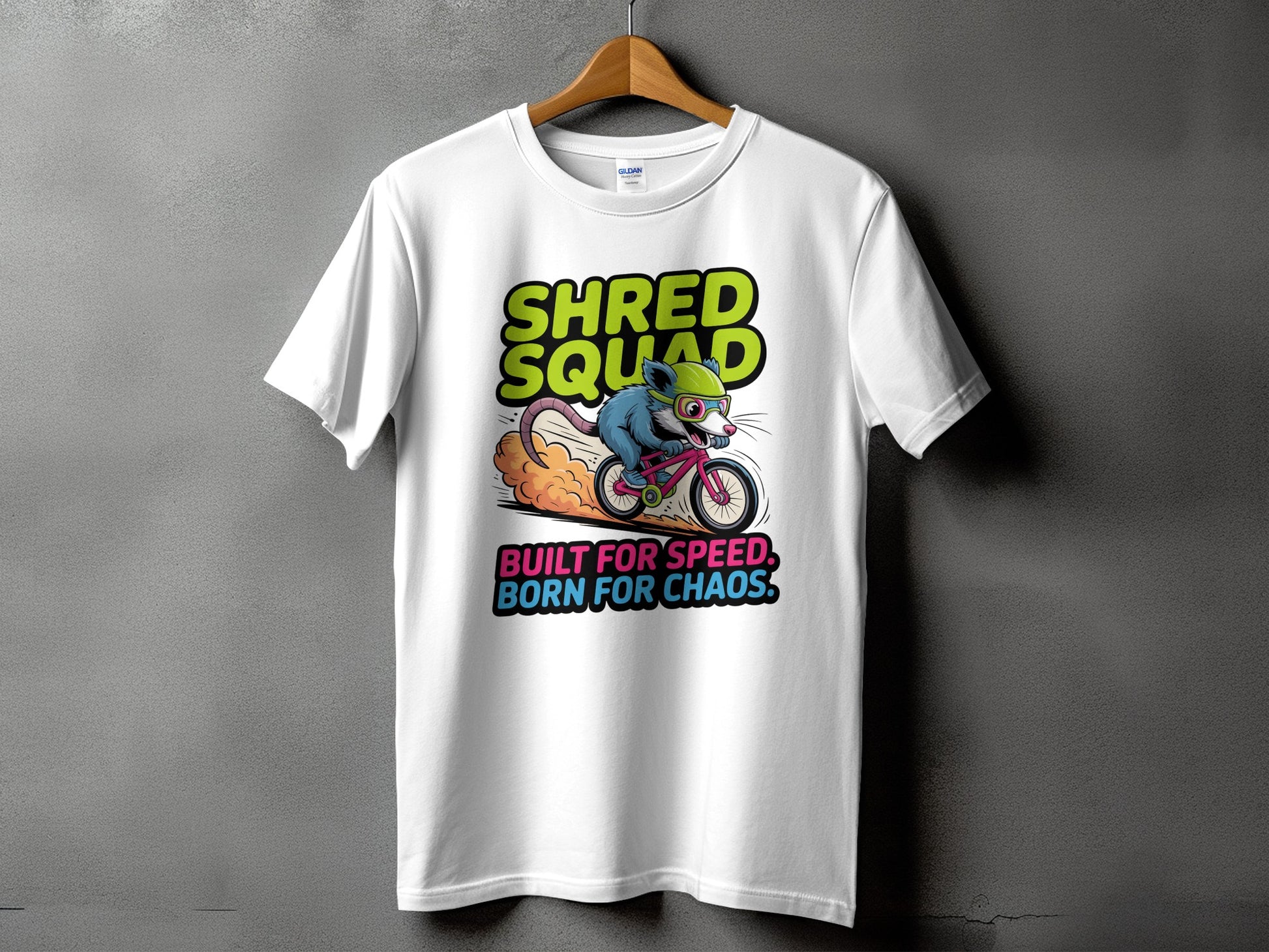 Shred Squad possum riding a BMX bike with "Built for Speed, Born for Chaos" graphic on a Gildan 5000 t-shirt
